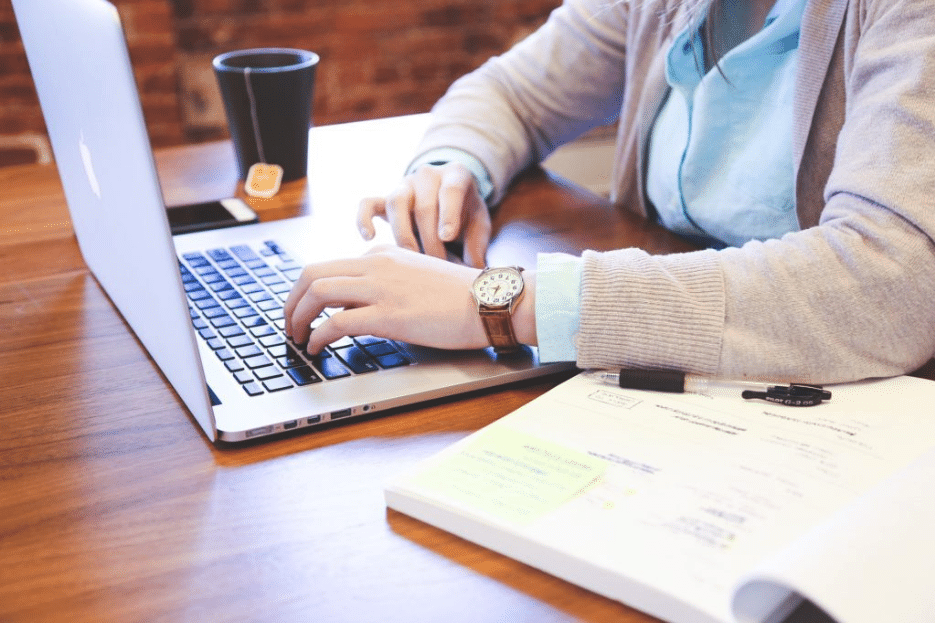 A woman uses her laptop to add Content Upgrades to her website.