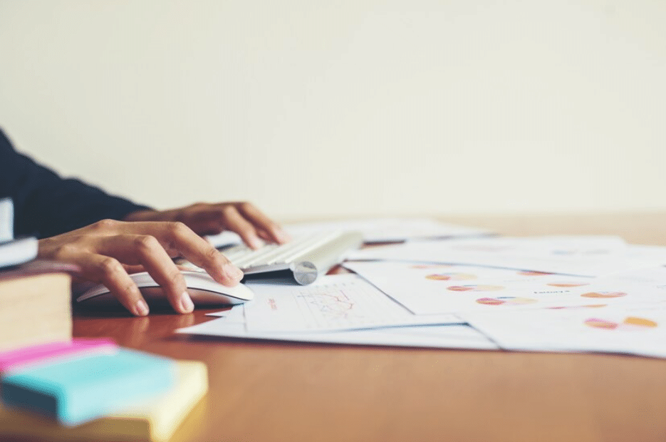 A man works at his desk to create edo bait content for his company. 